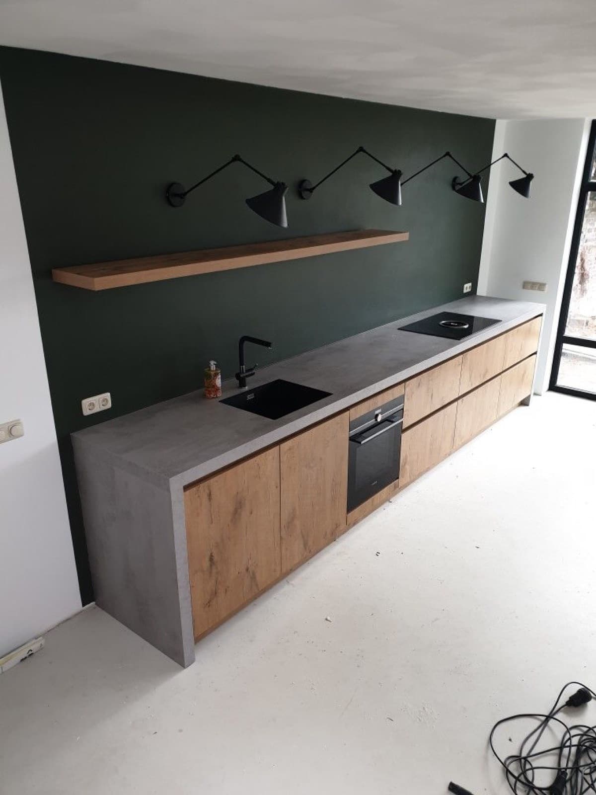 Microcement kitchen wall and worktop in a soft neutral finish