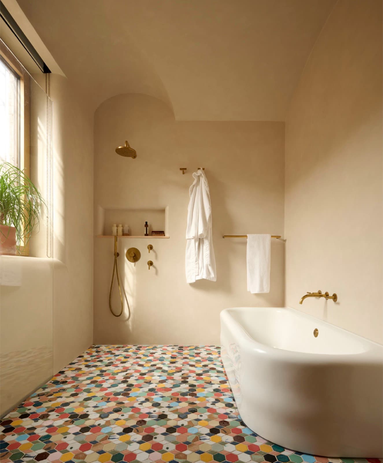 Tadelakt wet room with a curbless shower and continuous plaster running into the floor